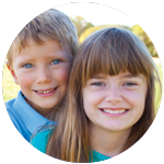 Young boy and girl standing together smiling