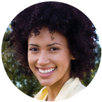 Young woman smiling in front of a tree